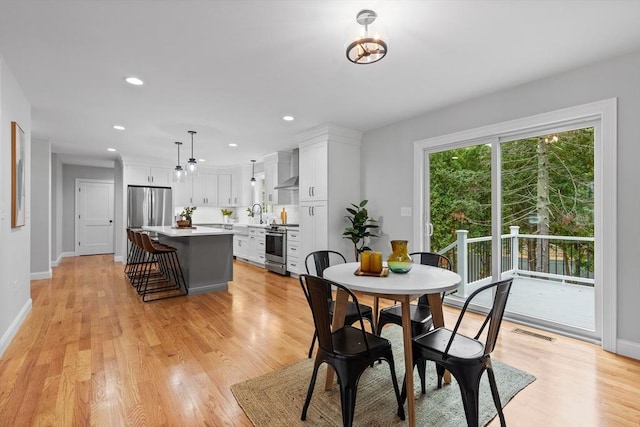 dining space featuring light hardwood / wood-style floors