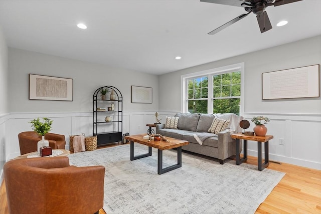 living room featuring ceiling fan and hardwood / wood-style floors