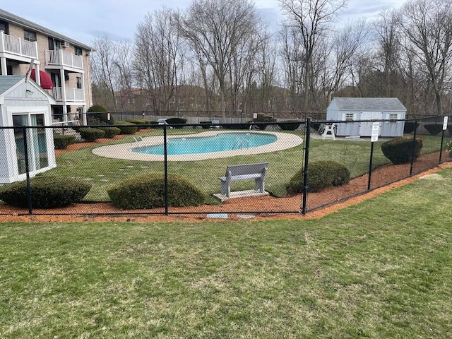 view of pool featuring fence and a yard