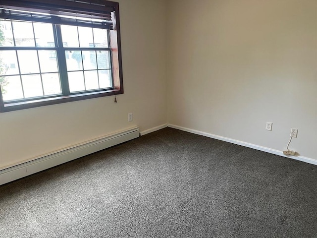 empty room featuring a baseboard radiator, dark carpet, and baseboards