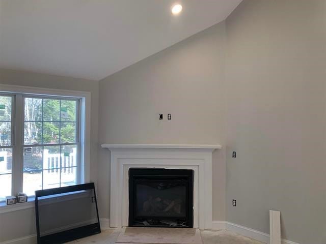 unfurnished living room featuring vaulted ceiling