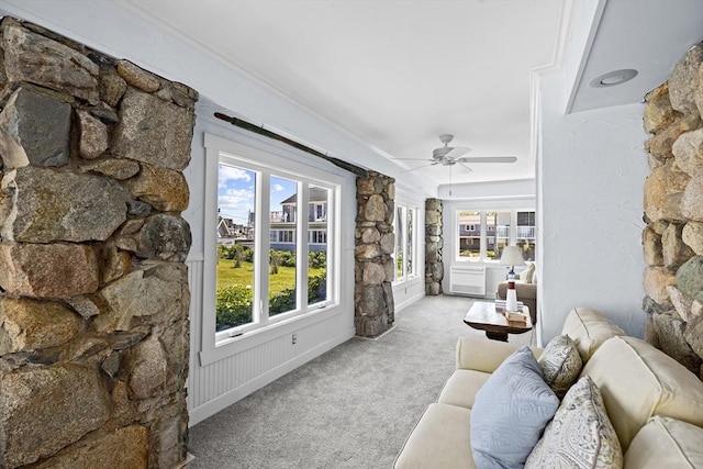 carpeted living room with ceiling fan