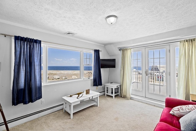 carpeted living room with baseboard heating, a textured ceiling, and vaulted ceiling