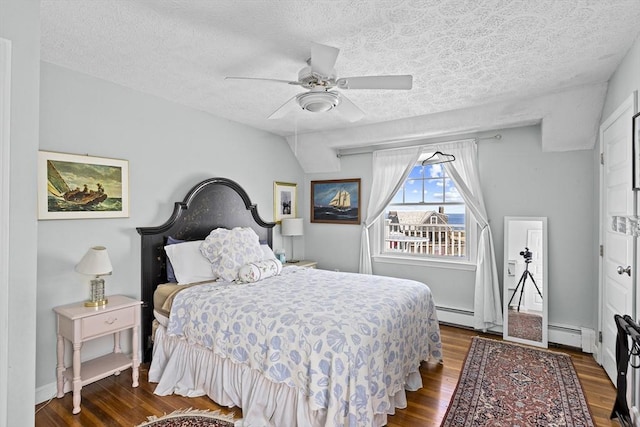 bedroom featuring ceiling fan, a baseboard radiator, hardwood / wood-style floors, and a textured ceiling