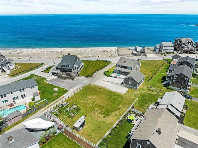 birds eye view of property featuring a beach view and a water view