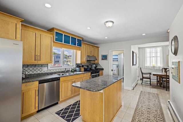 kitchen with baseboard heating, light tile patterned floors, a center island, and stainless steel appliances