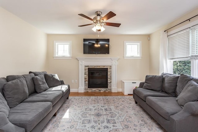 34 Bates St Unit 34, Abington, MA 02351 - living area with plenty of natural light, a ceiling fan, light wood finished floors, and a glass covered fireplace