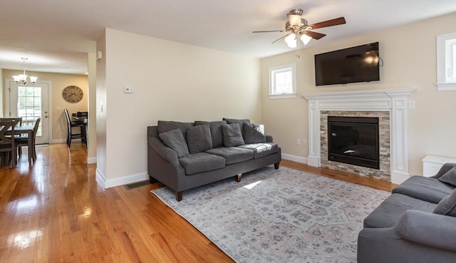 34 Bates St Unit 34, Abington, MA 02351 - living area with a chandelier, light wood-style floors, ceiling fan, and plenty of natural light