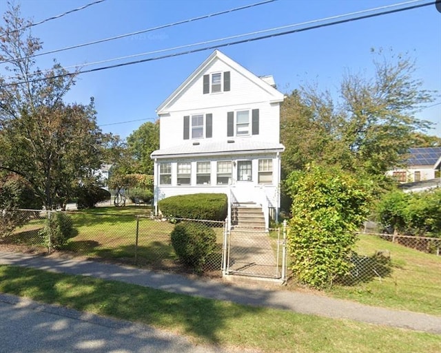 view of front facade featuring a fenced front yard, a front lawn, and a gate