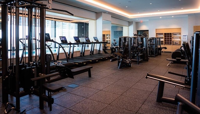 gym featuring a tray ceiling