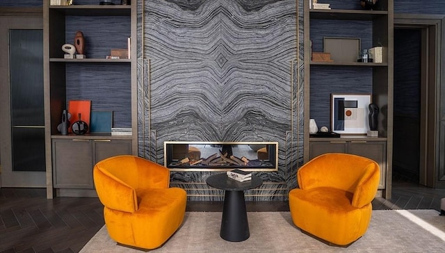 sitting room with built in shelves and parquet floors