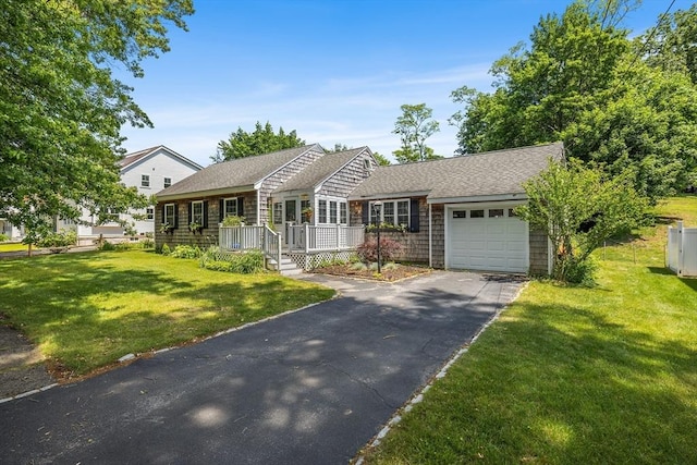 12 Norman Ave, Newburyport, MA 01950 - view of front of property featuring an attached garage, driveway, a front lawn, and a shingled roof