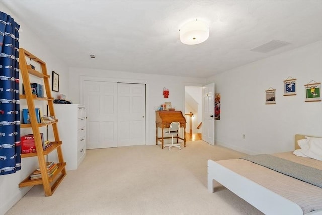 bedroom with light carpet and a closet