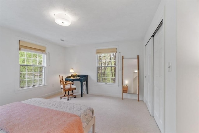 carpeted bedroom featuring a closet