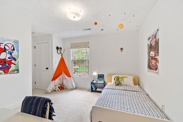 bedroom featuring carpet and baseboards