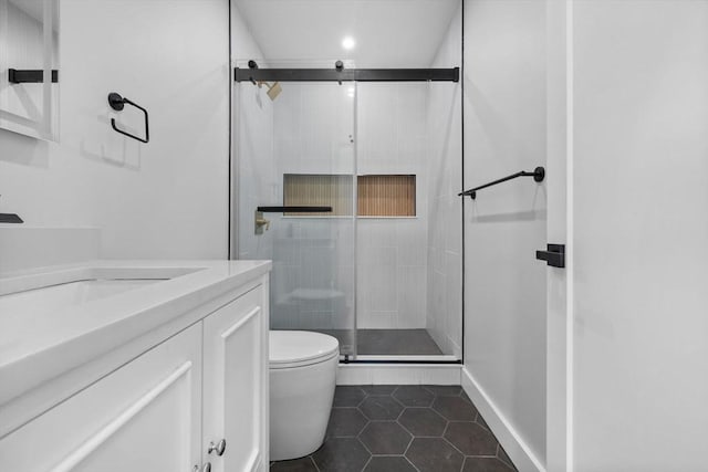 7 Denvir St Unit 2, Boston, MA 02124 - bathroom with toilet, tile patterned floors, a shower stall, vanity, and baseboards