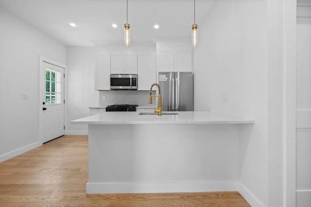 7 Denvir St Unit 2, Boston, MA 02124 - kitchen featuring appliances with stainless steel finishes, a sink, light countertops, white cabinetry, and baseboards