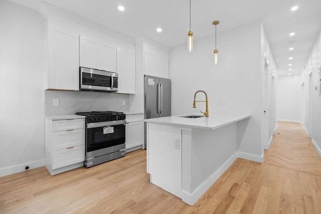 7 Denvir St Unit 2, Boston, MA 02124 - kitchen with stainless steel appliances, a sink, baseboards, recessed lighting, and white cabinets