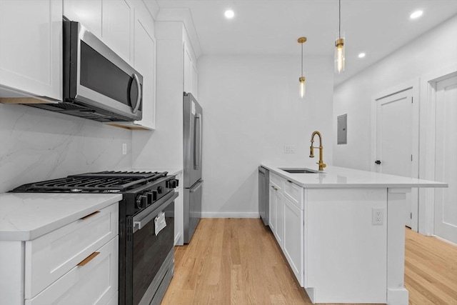 7 Denvir St Unit 2, Boston, MA 02124 - kitchen with stainless steel appliances, a sink, a peninsula, light wood-style floors, and recessed lighting