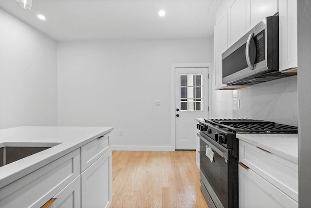 7 Denvir St Unit 2, Boston, MA 02124 - kitchen with stainless steel microwave, black gas stove, white cabinets, and recessed lighting