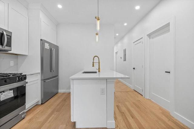 7 Denvir St Unit 2, Boston, MA 02124 - kitchen with stainless steel appliances, a sink, light wood-type flooring, recessed lighting, and white cabinets