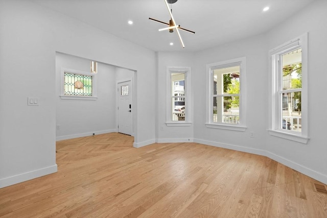 7 Denvir St Unit 2, Boston, MA 02124 - unfurnished living room with baseboards, light wood-type flooring, a chandelier, and recessed lighting