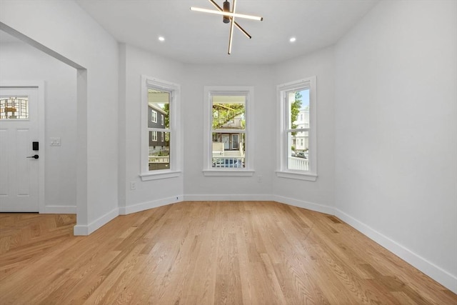 7 Denvir St Unit 2, Boston, MA 02124 - empty room with a chandelier, baseboards, light wood finished floors, and recessed lighting