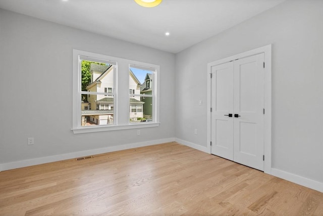 7 Denvir St Unit 2, Boston, MA 02124 - unfurnished bedroom featuring light wood finished floors, baseboards, a closet, and recessed lighting