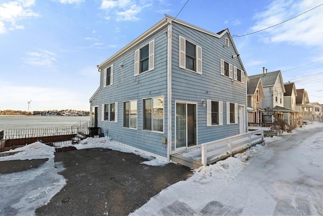 view of snow covered exterior featuring fence