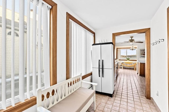 kitchen with light tile patterned floors and refrigerator