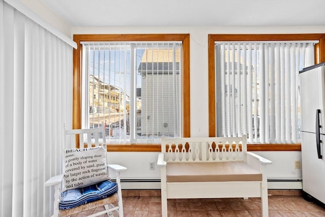 interior space with a baseboard heating unit and tile patterned floors