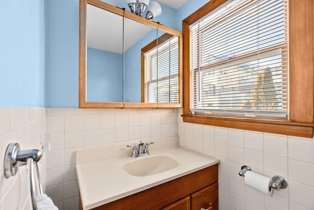 bathroom with tile walls, plenty of natural light, and vanity