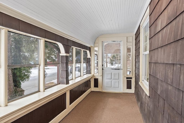 unfurnished sunroom featuring wood ceiling and vaulted ceiling