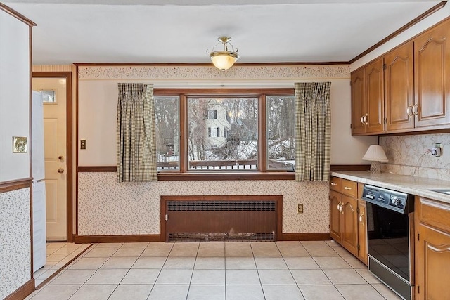 kitchen featuring light tile patterned flooring, black dishwasher, light countertops, radiator, and wallpapered walls