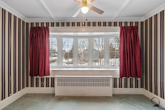 carpeted spare room with wallpapered walls, radiator heating unit, baseboards, and a wealth of natural light