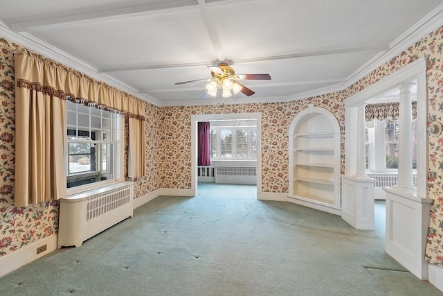 carpeted spare room with ornate columns, radiator, ornamental molding, and wallpapered walls