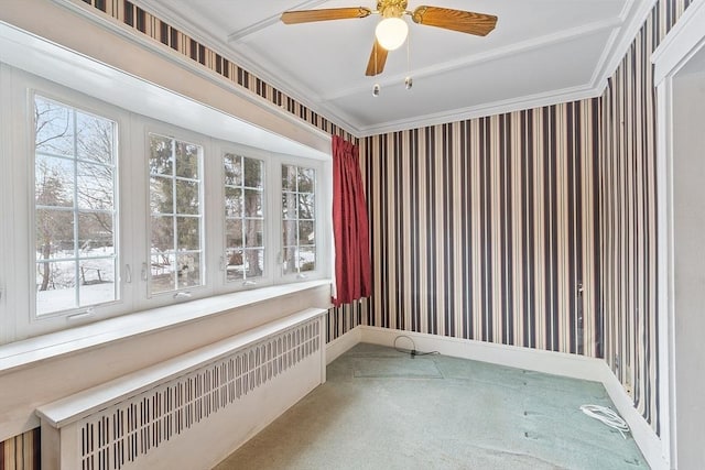 empty room with radiator heating unit, carpet flooring, ceiling fan, baseboards, and wallpapered walls