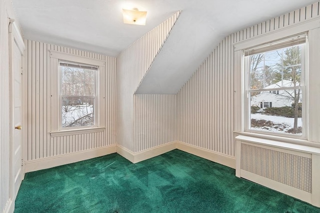 bonus room with carpet, radiator heating unit, and baseboards