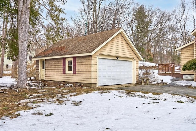 snow covered garage with a garage