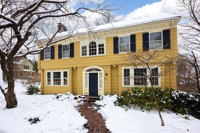 colonial inspired home with a chimney