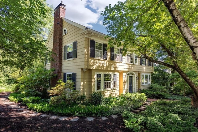 colonial-style house with a chimney