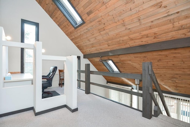 additional living space featuring light carpet, lofted ceiling with skylight, and wooden ceiling