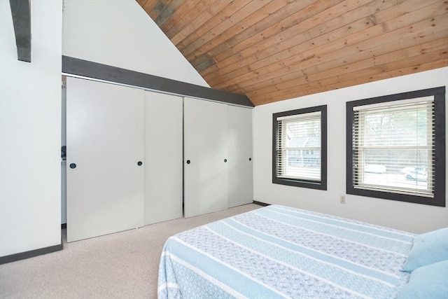 bedroom featuring light carpet, a closet, wood ceiling, and vaulted ceiling