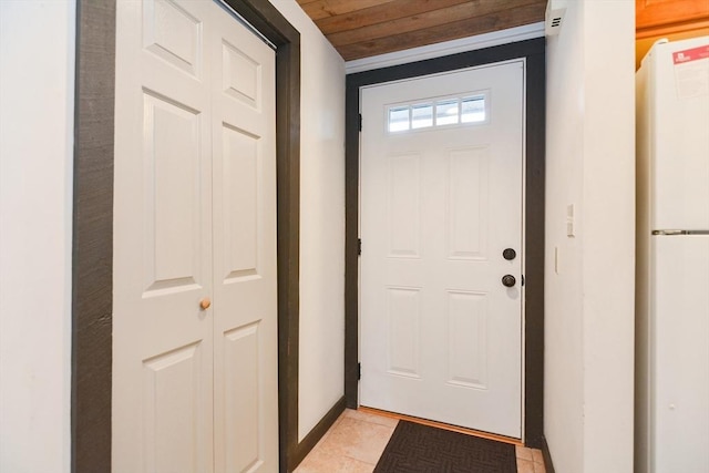 entryway with light tile patterned floors and wood ceiling