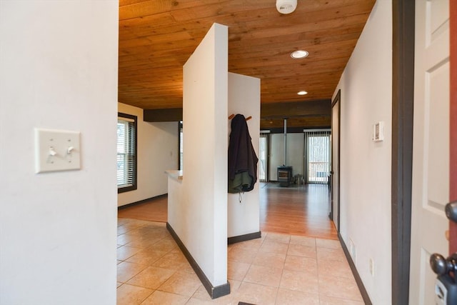 corridor featuring light tile patterned floors and wooden ceiling