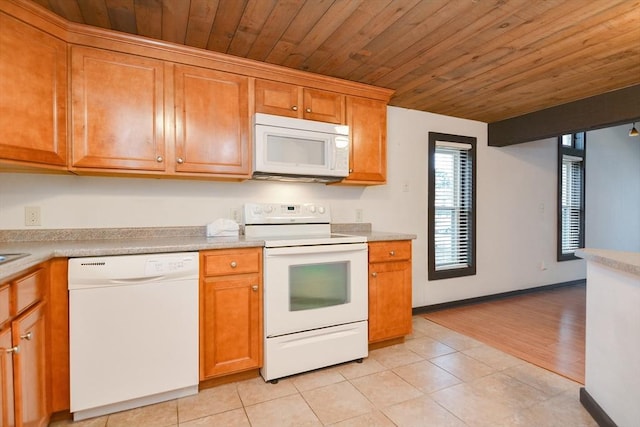 kitchen with light tile patterned flooring and white appliances