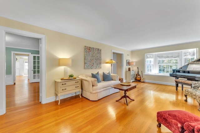 living room featuring wood-type flooring and ornamental molding