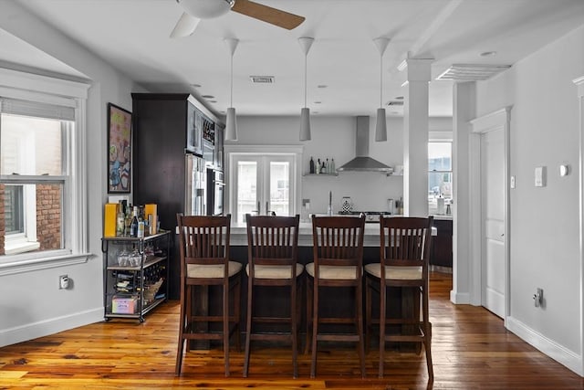 733 E 3rd St, Boston, MA 02127 - dining area with hardwood / wood-style floors, a ceiling fan, baseboards, and ornate columns