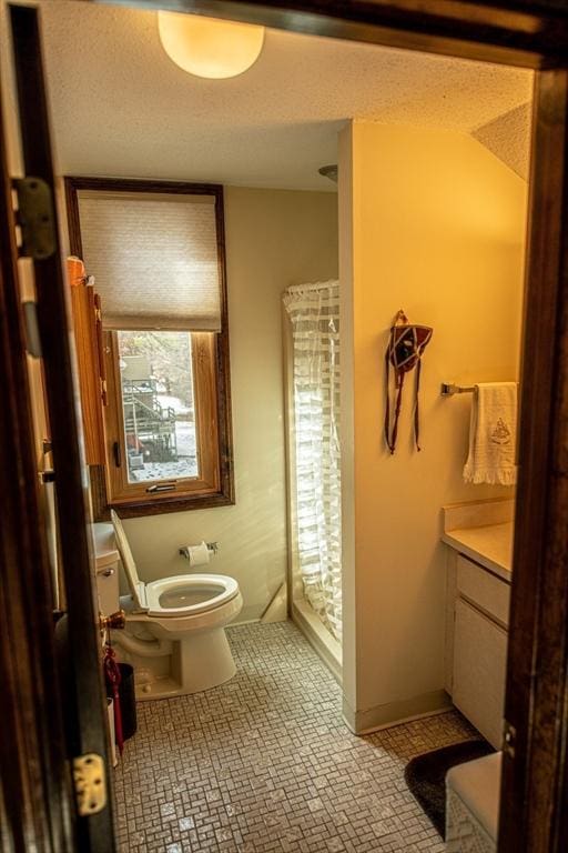 bathroom with toilet, tile patterned floors, and vanity