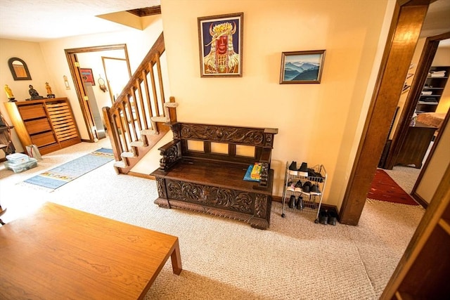 interior space with carpet floors, baseboards, and stairway